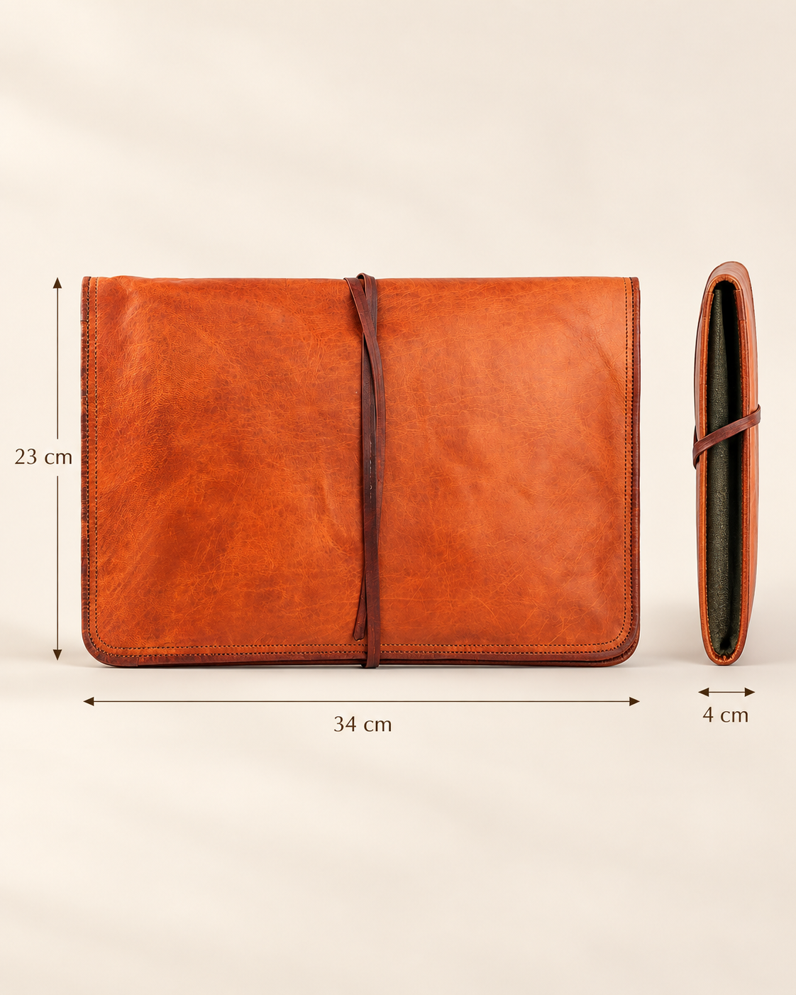 An orange-brown leather laptop sleeve cover shown on a light beige background with dimension lines indicating measurements of 34 cm width, 23 cm height, and 4 cm thickness.
