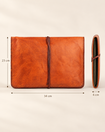 An orange-brown leather laptop sleeve cover shown on a light beige background with dimension lines indicating measurements of 34 cm width, 23 cm height, and 4 cm thickness.